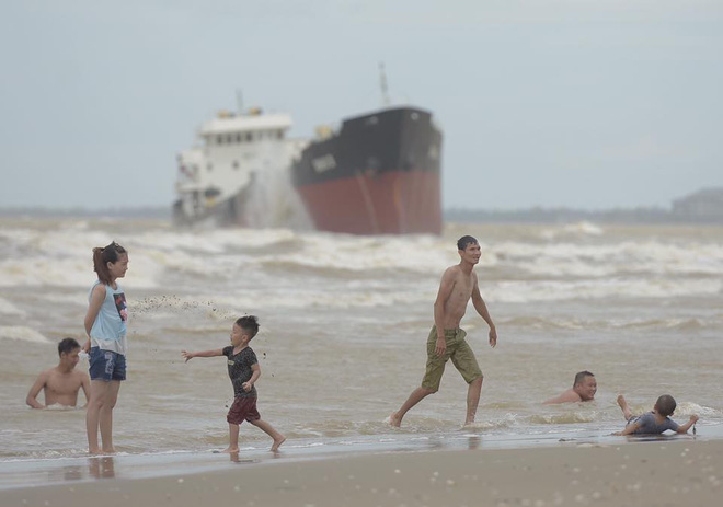 Chùm ảnh: Bất chấp sóng to gió lớn sau bão số 2, nhiều gia đình vẫn đưa trẻ em ra tắm biển Cửa Lò - Ảnh 6.