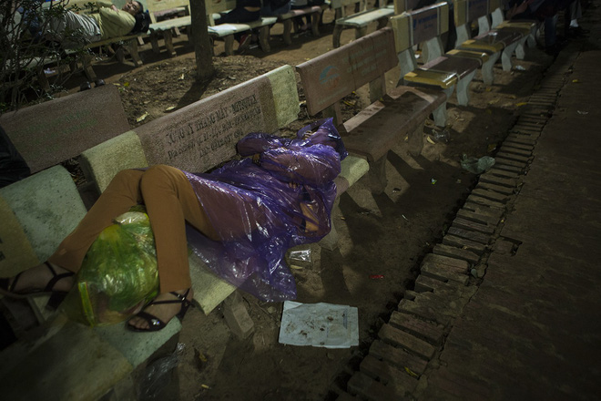Người phụ nữ mặc áo mưa, ngủ qua đêm trên ghế đá chờ xin ấn đền Trần - Ảnh 5.