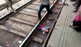 Clip hot: Bé gái 1 tuổi nằm dưới đường ray khi tàu chạy qua