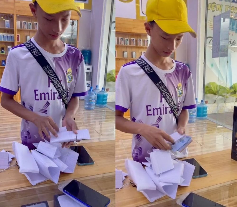 Cậu bé để dành tiền để mua được chiếc điện thoại như mong muốn. (Ảnh: Cắt từ clip) Cậu bé để dành tiền để mua được chiếc điện thoại như mong muốn. (Ảnh: Cắt từ clip)